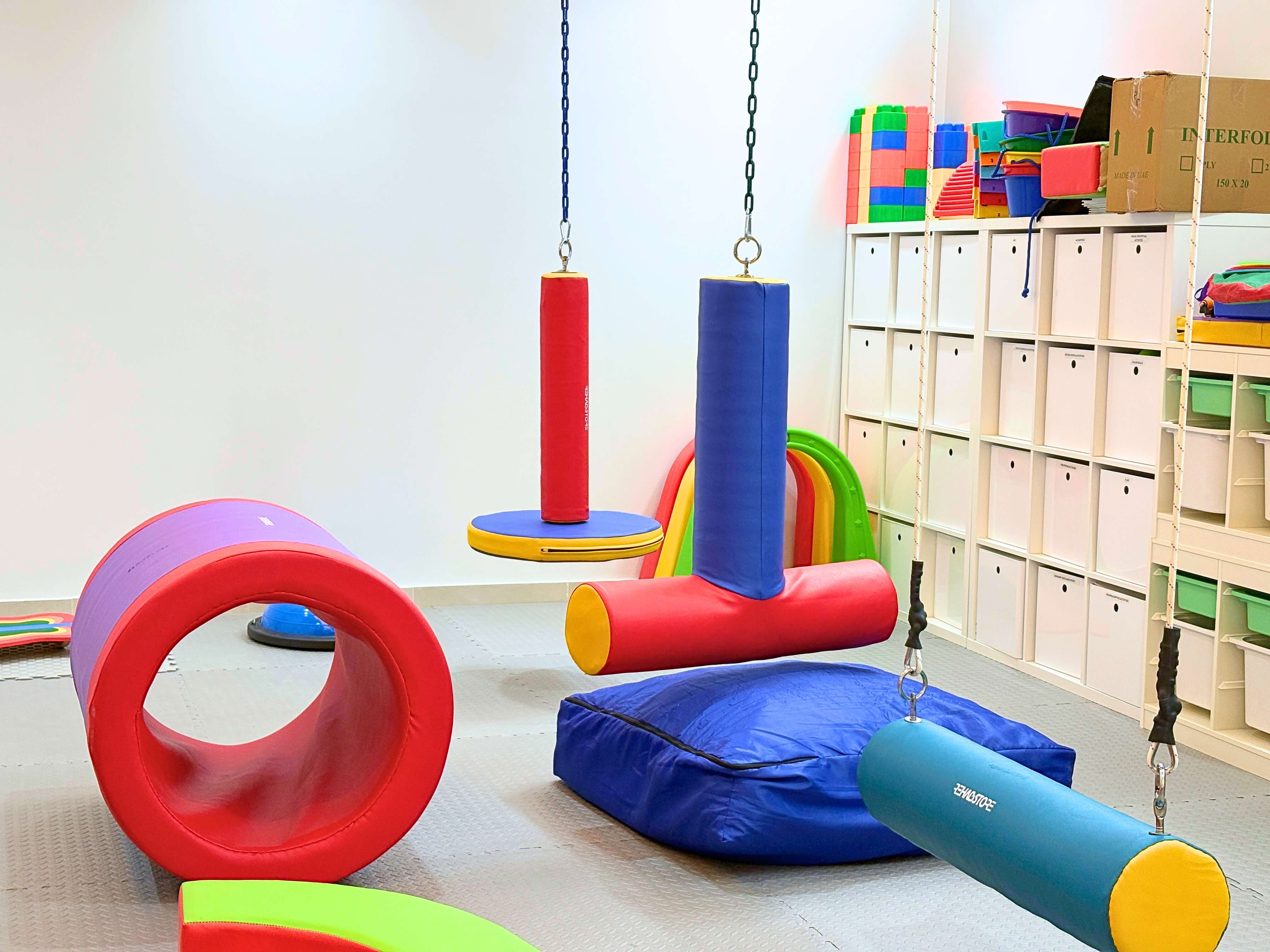 Physiotherapy and rehabilitation suite at Bridges Care Speech Therapy Center - barrels, swings, bolsters and graded motor-planning equipment
