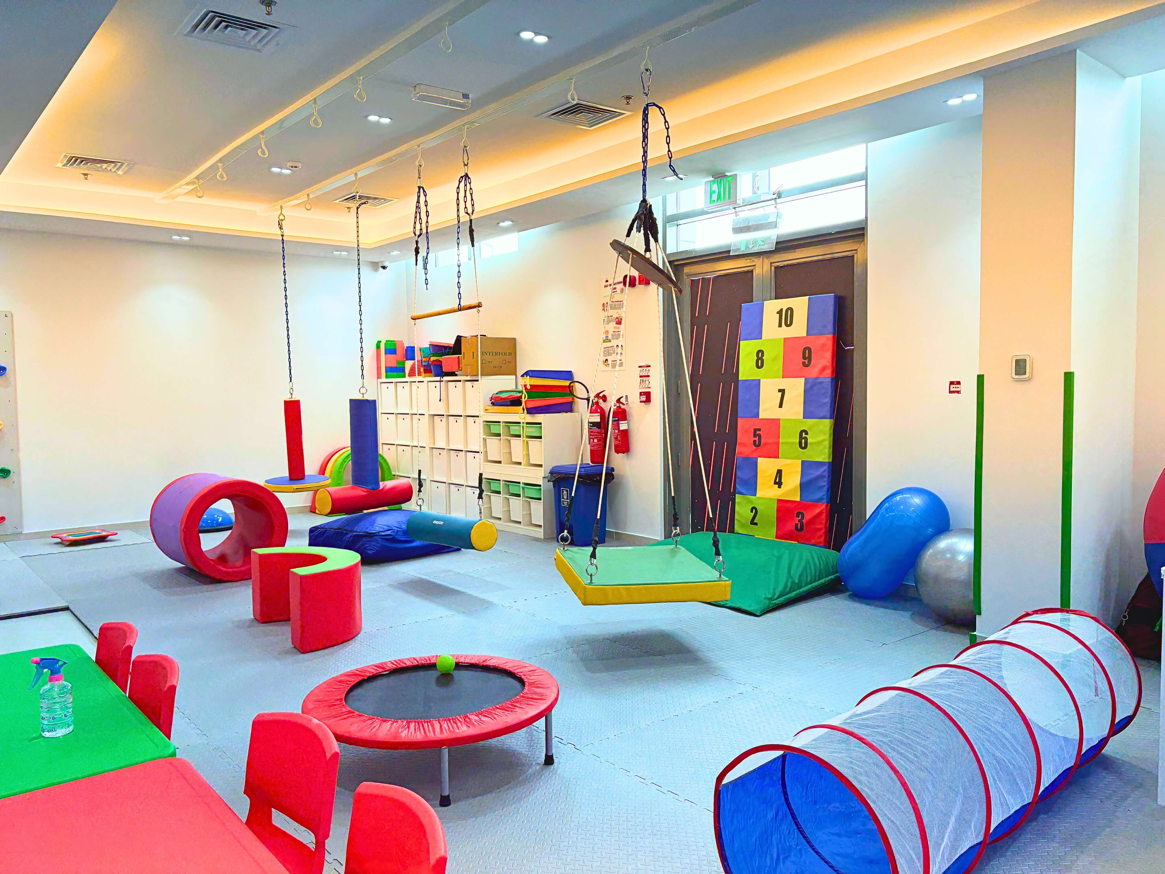 Occupational therapy gym at Bridges Care Speech Therapy Center - swings, climbing equipment, motor-planning apparatus and sensory tools under one roof